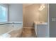 Bathroom includes a soaking tub and separate sink and vanity at 1464 Claredon Dr, Lawrenceville, GA 30043