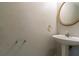 Powder room featuring a pedestal sink and a round mirror at 1464 Claredon Dr, Lawrenceville, GA 30043