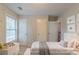 Stylized bedroom with a modern bed, soft bedding, and ample natural light showcasing its cozy ambiance at 1464 Claredon Dr, Lawrenceville, GA 30043