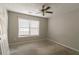 This bedroom features natural light from a window and overhead fan at 1464 Claredon Dr, Lawrenceville, GA 30043