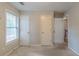Bedroom featuring a window and multiple doors leading to different areas of the house at 1464 Claredon Dr, Lawrenceville, GA 30043