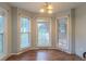 Bright breakfast nook with natural light, wood floors, and a stylish chandelier at 1464 Claredon Dr, Lawrenceville, GA 30043