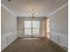 Classic dining room with chandelier lighting, bright window, and neutral wall paint at 1464 Claredon Dr, Lawrenceville, GA 30043