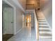 Bright entryway featuring tiled floors, a staircase, and access to other rooms in the home at 1464 Claredon Dr, Lawrenceville, GA 30043
