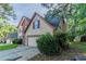 Charming two-story home with a brick accent, attached garage, and mature trees at 1464 Claredon Dr, Lawrenceville, GA 30043