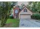 Charming two-story home with a brick accent and a well-maintained front yard at 1464 Claredon Dr, Lawrenceville, GA 30043