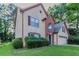 Charming two-story home with a brick accent, attached garage, and a well-maintained lawn at 1464 Claredon Dr, Lawrenceville, GA 30043