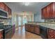 Well-equipped kitchen featuring dark wood cabinetry, tile backsplash, and modern appliances at 1464 Claredon Dr, Lawrenceville, GA 30043