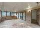 Enclosed sunroom featuring a wood floor, a wall of windows, and a door leading to the interior of the home at 1464 Claredon Dr, Lawrenceville, GA 30043