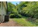 Lush backyard with mature trees surrounding the property at 2935 Catalina Dr, Decatur, GA 30032