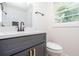 Bathroom featuring a dark vanity, white countertops, black fixtures and a mirror at 2935 Catalina Dr, Decatur, GA 30032