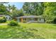 Charming single story home with a well-manicured lawn and mature trees providing shade at 2935 Catalina Dr, Decatur, GA 30032