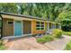 Exterior shot of home with a blue door and wood and stone accents at 2935 Catalina Dr, Decatur, GA 30032
