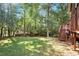 The property includes a spacious backyard and stairway leading to the deck at 5204 Tealing Ne Dr, Roswell, GA 30075