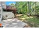 Backyard shows a concrete patio, stairs to upper deck, and large grassy area at 5204 Tealing Ne Dr, Roswell, GA 30075