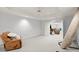 Spacious basement area featuring comfortable seating, neutral colors, and ample light at 5204 Tealing Ne Dr, Roswell, GA 30075