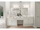 Elegant bathroom featuring a double vanity, ample lighting, and luxurious finishes for a sophisticated space at 5204 Tealing Ne Dr, Roswell, GA 30075