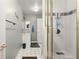 Bathroom featuring a shower, sink, and white tiled flooring at 5204 Tealing Ne Dr, Roswell, GA 30075