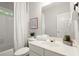 Well-lit bathroom with a shower, tub, and vanity with ample storage and decorative accents at 5204 Tealing Ne Dr, Roswell, GA 30075