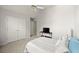 Neutral bedroom with a ceiling fan, double closet, and neutral carpet at 5204 Tealing Ne Dr, Roswell, GA 30075