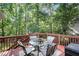 Outdoor deck features seating and a peaceful view of the surrounding trees at 5204 Tealing Ne Dr, Roswell, GA 30075