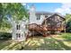 Exterior view of the home features a deck, screened-in porch, and well-kept lawn at 5204 Tealing Ne Dr, Roswell, GA 30075