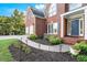 Lovely landscaped front yard with blooming flowers and brick facade on a two-story home at 5204 Tealing Ne Dr, Roswell, GA 30075