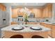 Charming kitchen features stainless steel appliances, an island with granite counters and light-colored cabinetry at 5204 Tealing Ne Dr, Roswell, GA 30075