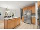 Spacious kitchen features stainless steel appliances, an island with seating, light-colored cabinetry and access to the dining area at 5204 Tealing Ne Dr, Roswell, GA 30075