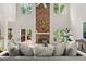 Bright living room features a stone fireplace, soaring ceilings, large windows, and comfortable furniture at 5204 Tealing Ne Dr, Roswell, GA 30075