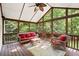Cozy screened porch with comfortable seating and a ceiling fan at 5204 Tealing Ne Dr, Roswell, GA 30075