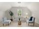 Inviting sitting area with comfortable seating, a large window, and neutral decor for a relaxing atmosphere at 5204 Tealing Ne Dr, Roswell, GA 30075