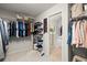 Walk-in closet with ample shelving and rod space for storage, plus carpet flooring at 5204 Tealing Ne Dr, Roswell, GA 30075