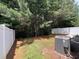 View of the grassy backyard with a white fence and shade trees at 5345 Mountain Top Pl, Cumming, GA 30041