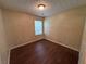 This bedroom boasts attractive laminate flooring and a large window at 5345 Mountain Top Pl, Cumming, GA 30041