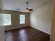 Serene bedroom with a ceiling fan and dual windows providing natural light at 5345 Mountain Top Pl, Cumming, GA 30041