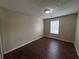 Bedroom with neutral walls, attractive floors, and large window at 5345 Mountain Top Pl, Cumming, GA 30041