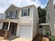 Side view of a two-story home featuring an attached garage and a well-maintained yard at 5345 Mountain Top Pl, Cumming, GA 30041