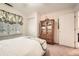 Well-lit bedroom featuring a large window, closet, and an armoire for ample storage at 3196 Henderson Walk, Atlanta, GA 30340