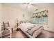 Comfortable bedroom with white spindle bed frame, neutral walls, and soft, natural lighting at 3196 Henderson Walk, Atlanta, GA 30340