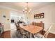 Dining room with hardwood floors, wooden table, and easy access to the living room at 3196 Henderson Walk, Atlanta, GA 30340