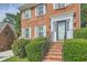 Close up of the front of this brick home with stairs to the door and manicured bushes at 3196 Henderson Walk, Atlanta, GA 30340