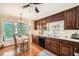Bright kitchen boasts hardwood floors, dark wood cabinets, and eat-in breakfast nook at 3196 Henderson Walk, Atlanta, GA 30340