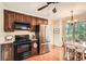 Open kitchen features stainless steel appliances, dark cabinets and a view to breakfast nook at 3196 Henderson Walk, Atlanta, GA 30340