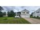 Inviting home featuring a well-maintained lawn, charming porch, and convenient two-car garage at 341 Brookside Dr, Mcdonough, GA 30253
