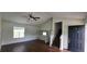 Bright living room featuring hardwood floors, ceiling fan and access to the staircase at 341 Brookside Dr, Mcdonough, GA 30253