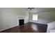 Spacious living room with a fireplace, high ceilings, and rich hardwood flooring at 341 Brookside Dr, Mcdonough, GA 30253