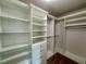 Spacious walk-in closet with custom shelving and ample storage space at 5535 Bright Cross Way, Suwanee, GA 30024