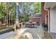 A spacious wooden deck perfect for outdoor dining and relaxing with lush greenery in the background at 8900 River Trace Dr, Johns Creek, GA 30097