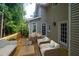 Back deck with outdoor seating and table overlooking the wooded backyard at 1096 Polo Club Nw Dr, Marietta, GA 30064